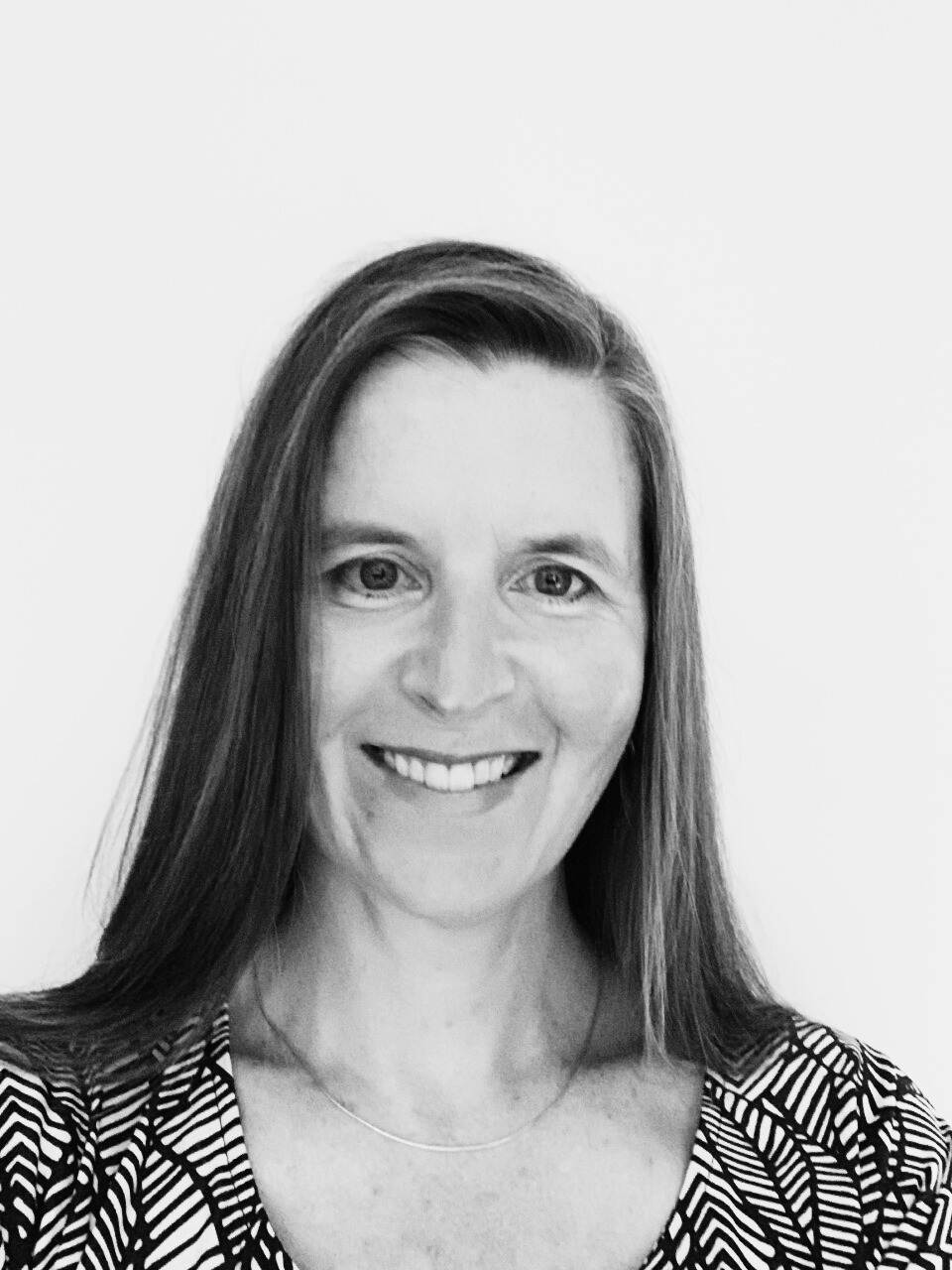 an image of Stacy Finnbogason who is smiling with long straight hair past her shoulders.